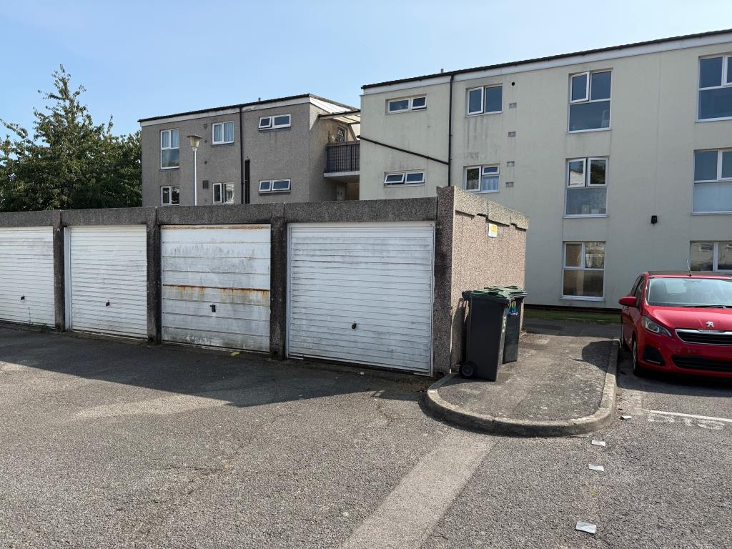 Lot: 175 - GROUND FLOOR FLAT FOR IMPROVEMENT - View of garage from communal car park